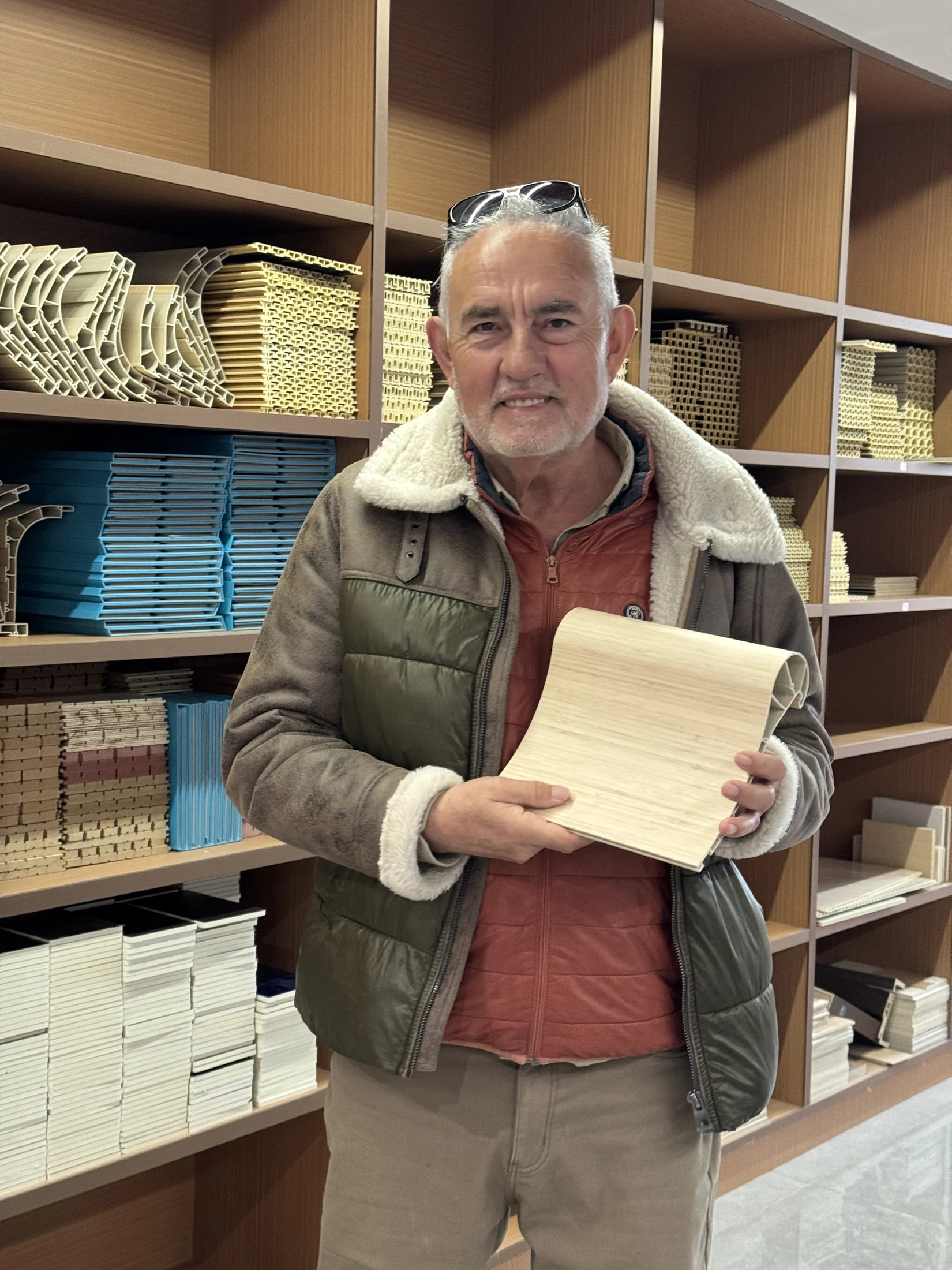 A visitor comparing a physical sample in the showroom